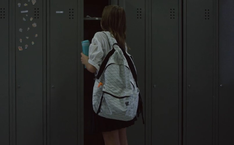 Girl using her locker in a school