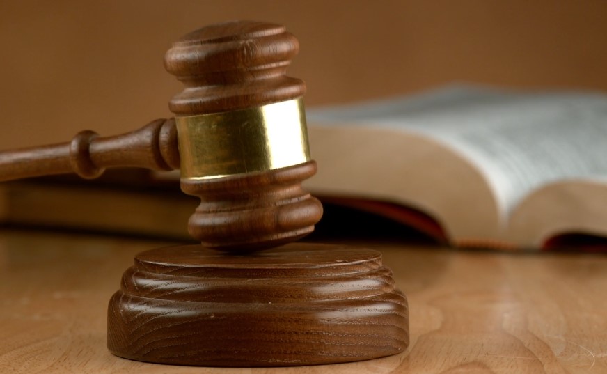 Judge's gavel resting on a wooden table, symbolizing authority and the judicial process