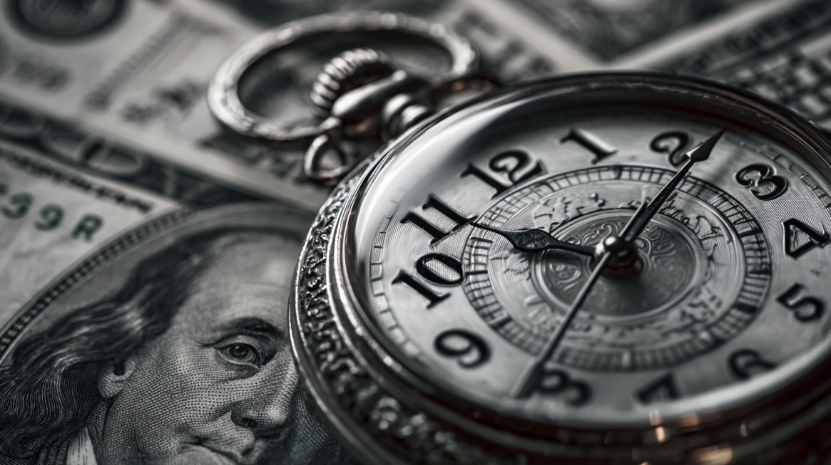 Close-up of a pocket watch on top of U.S. dollar bills, symbolizing hourly legal fees
