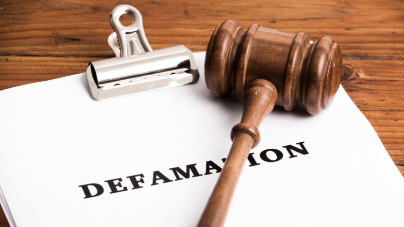 Gavel placed on a document labeled defamation, symbolizing how damages are calculated in defamation cases