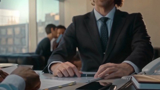 Business professionals reviewing documents during an H-1B visa eligibility meeting
