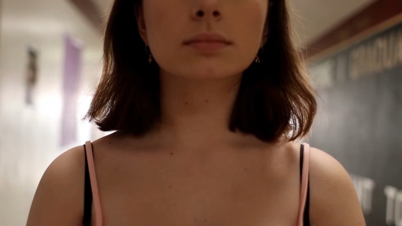 Student standing in a school hallway, related to rules on hairstyles and clothing in public and private schools