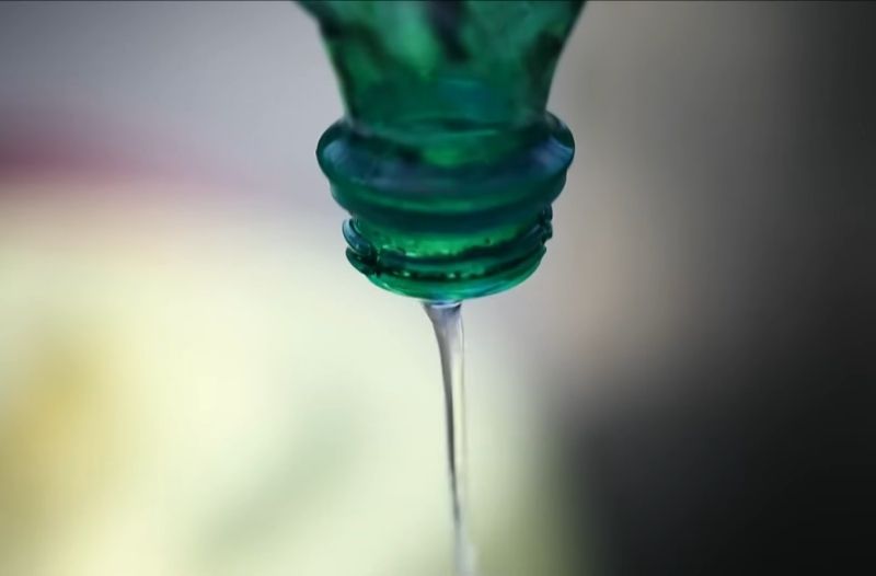 Close up of liquid pouring from a bottle, representing a regulated pollutant discharge.